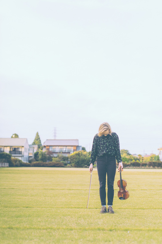 outdoor portrait of violinist looking down
