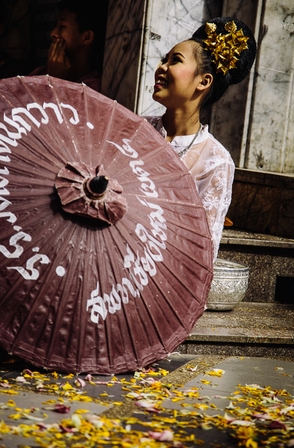 Thai girl behind umbrella smiling