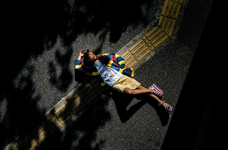 Marie Nakagawa laying on the street