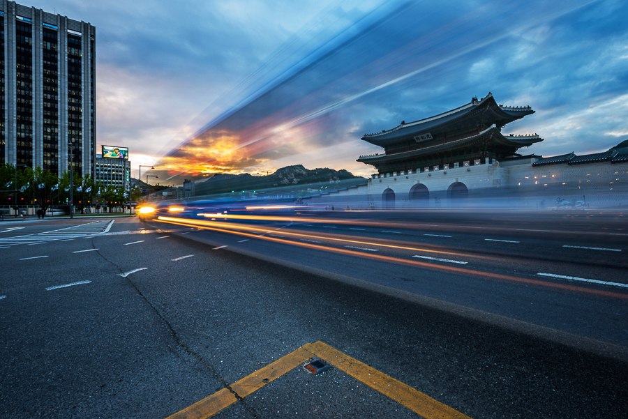 Light trails on a Seoul street with royal palace Gyeongbukgung in the background