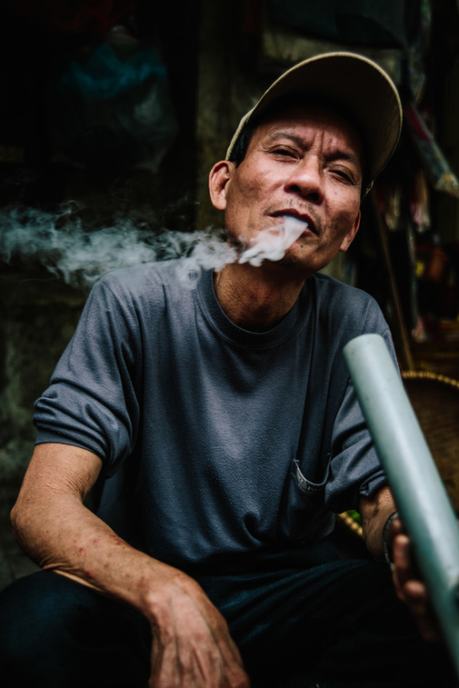 Man smoking on a water pipe in Vietnam