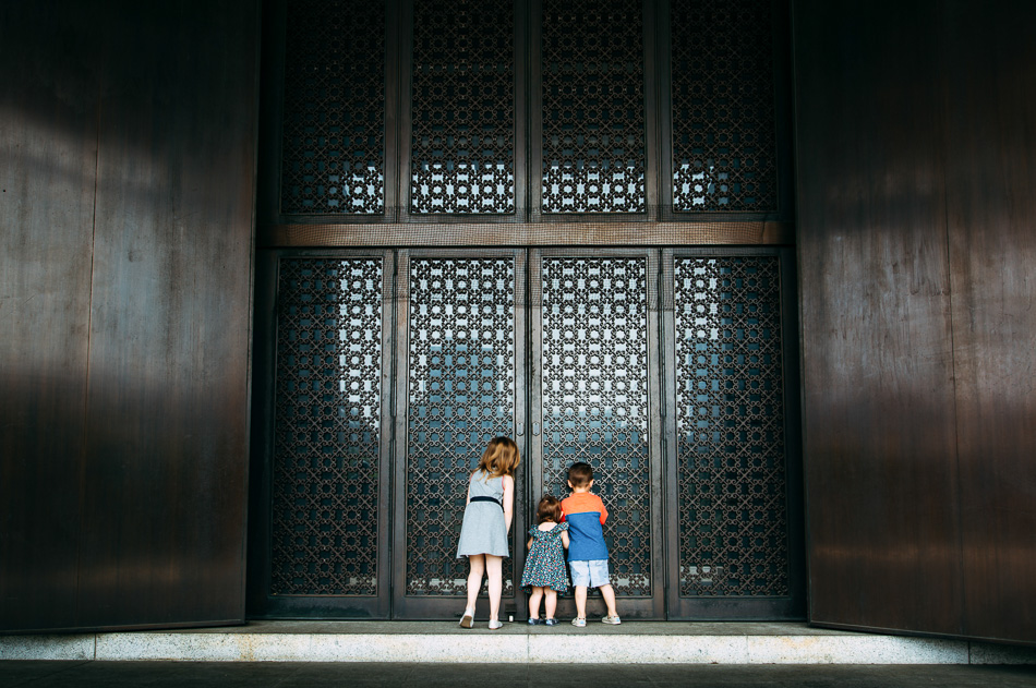 Three kids peeking through door