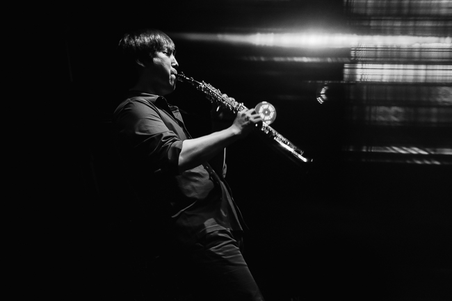 man plays alto saxophone