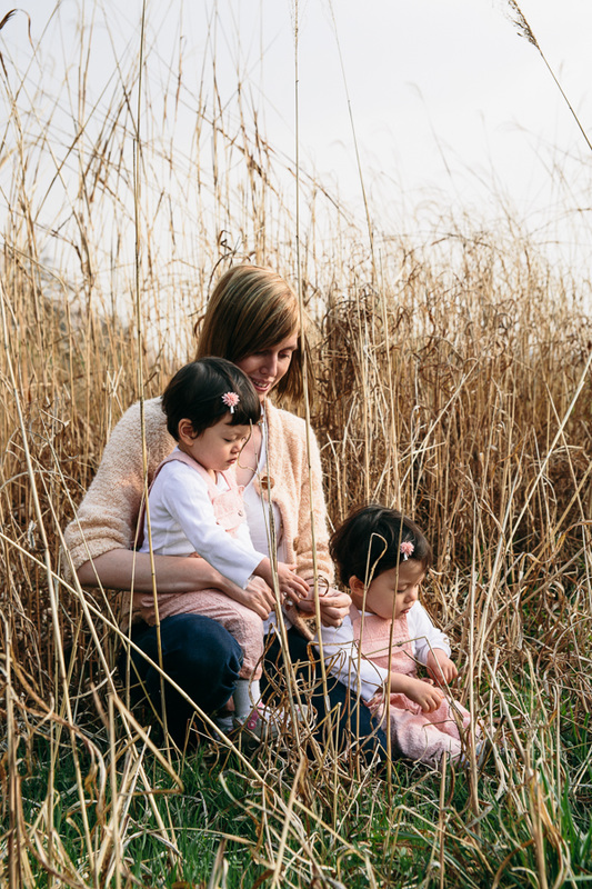 mother and twin daughters in a field