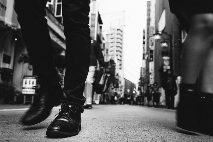 man's shoe on pavement