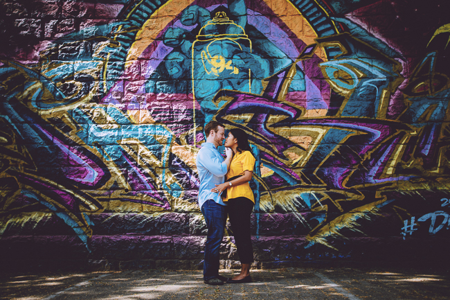 lovely pair in front of graffiti wall