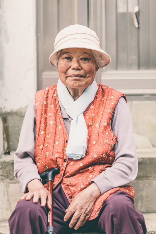 elderly Korean woman poses for a photograph