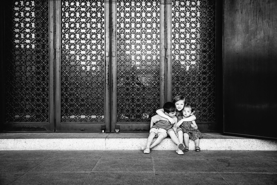 Three kids in front of temple doors