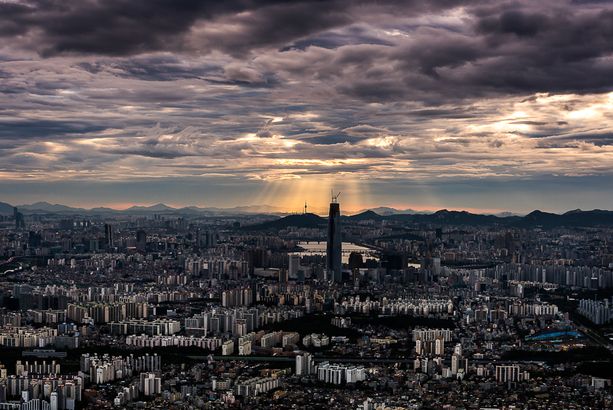 Seoul cityscape with brooding clouds with rays of light shining through