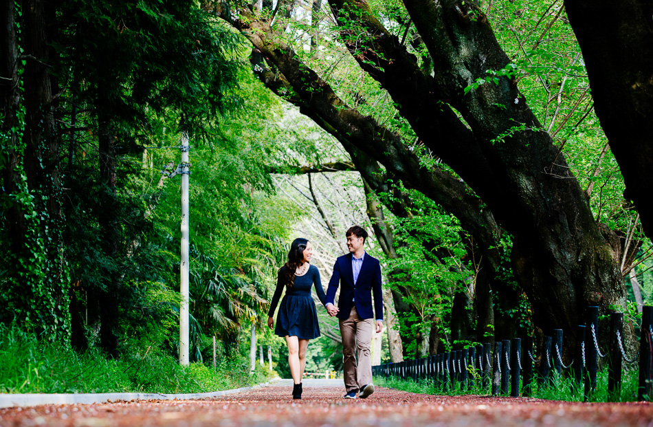 Megan and Michael walking down a path during their engagement photo session