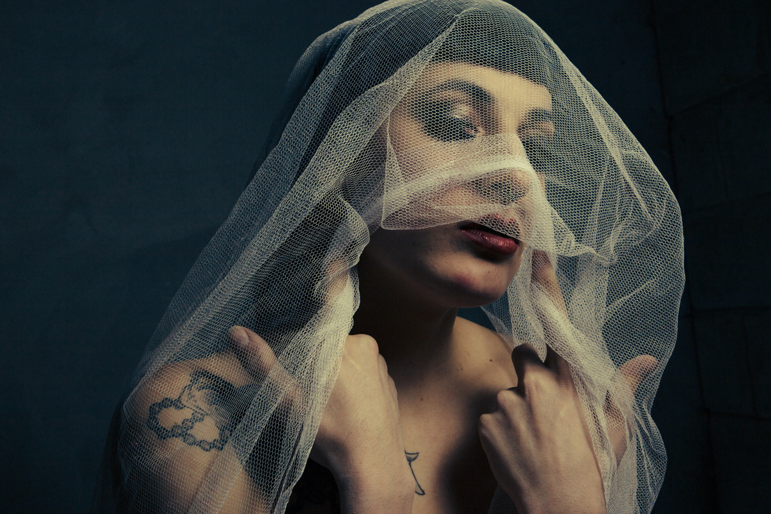 Beautiful girl with a veil over her face