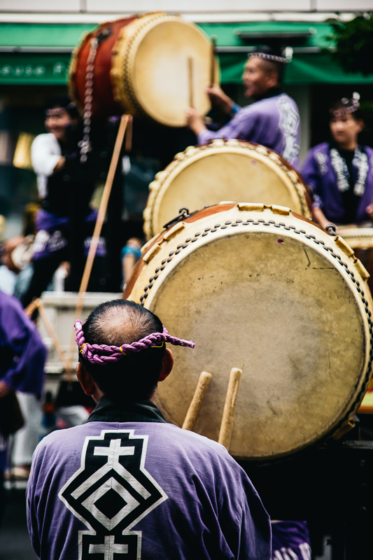 man beating taiko drum in Japan