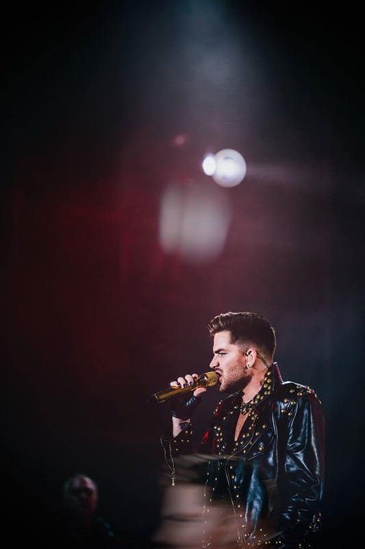 Adam Lambert sings into the microphone 
