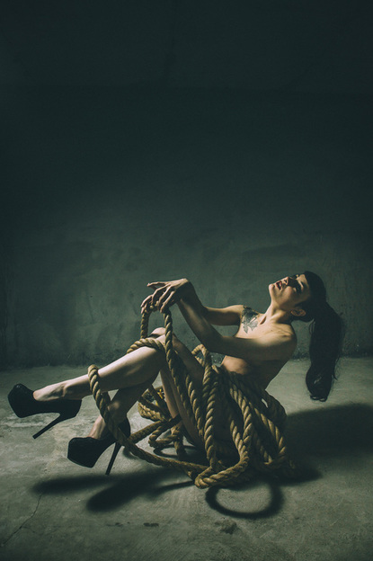 Portrait in Tokyo of girl with rope over legs