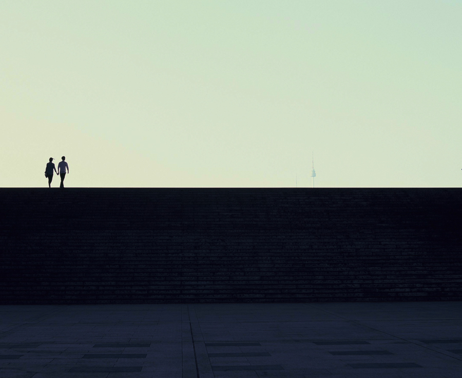 minimalist silhouette of a couple with N-Seoul tower in the distance