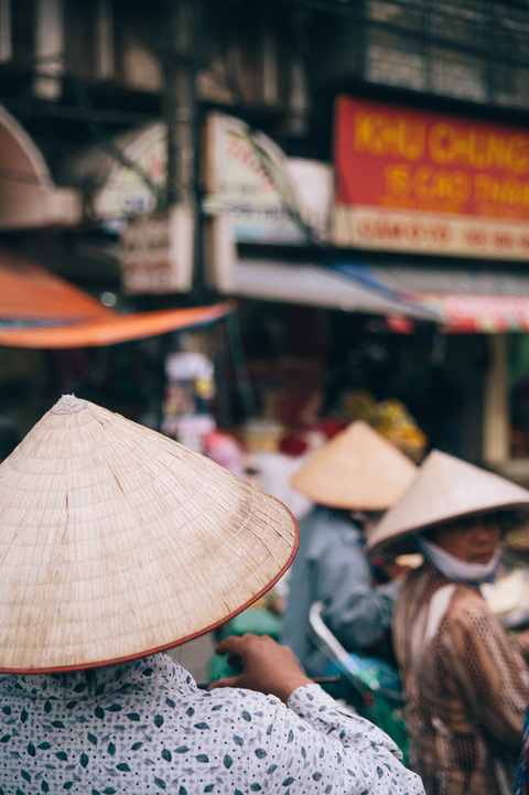 Vietnamese ladies wearing hats on the streets of Hanoi