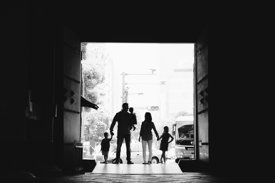 Silhouette of Schultz family in front of Zozoji temple doors
