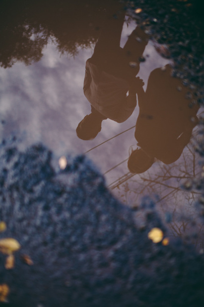 reflection of couple in a puddle