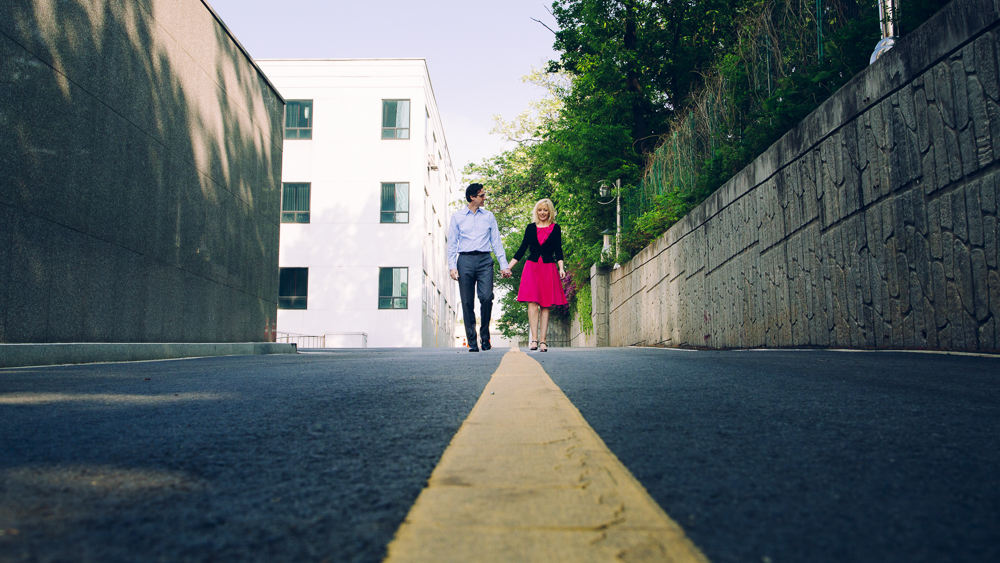 man and woman walking down road