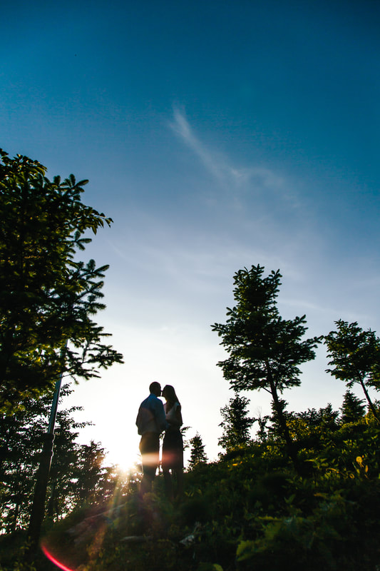 silhouette of lovers kissing in forest