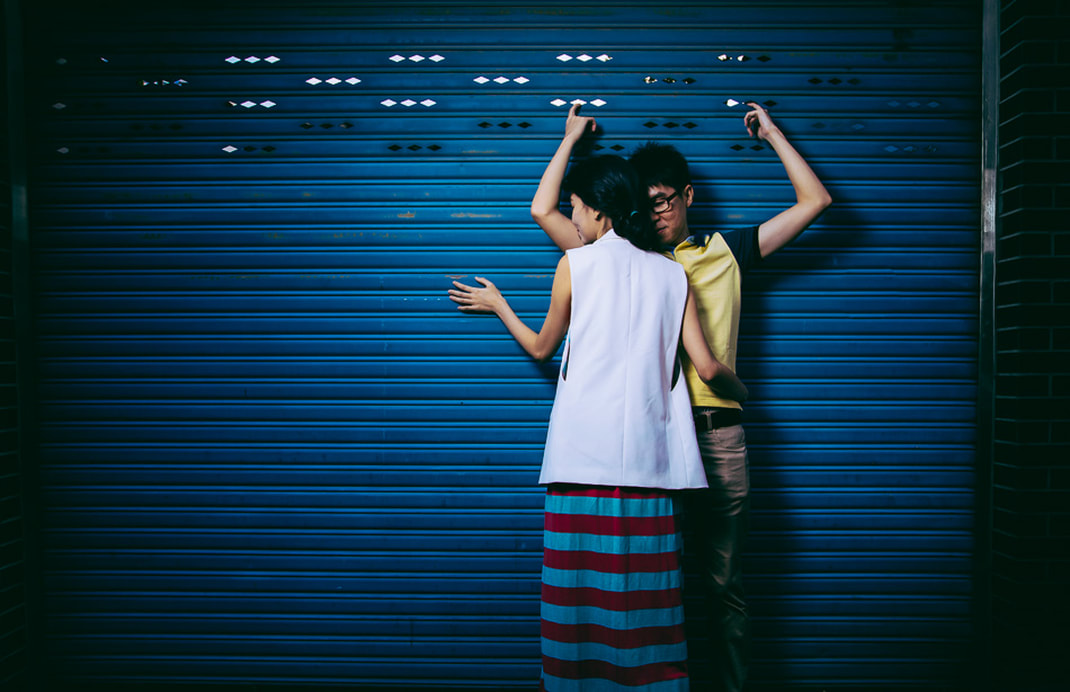 couple against a wall 