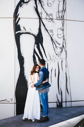 Couple in front of Tokyo graffiti