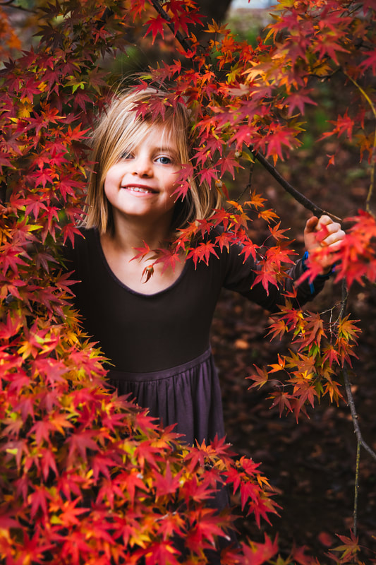 girl in red maple tree