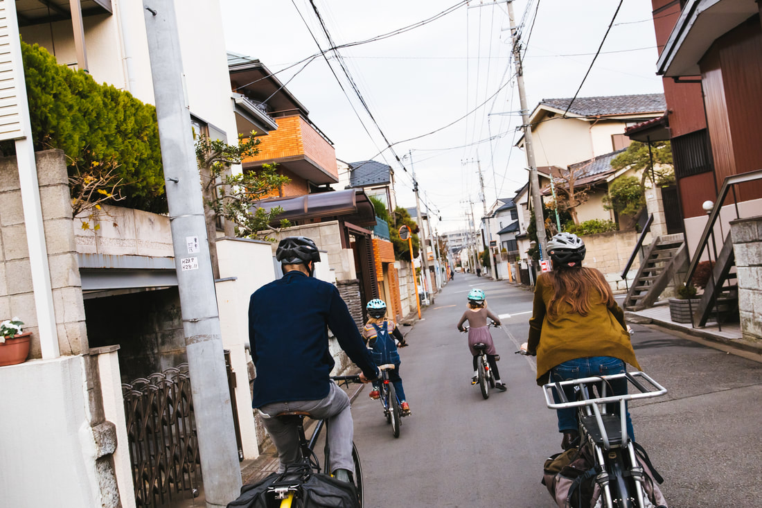 Family cycling through Koganei