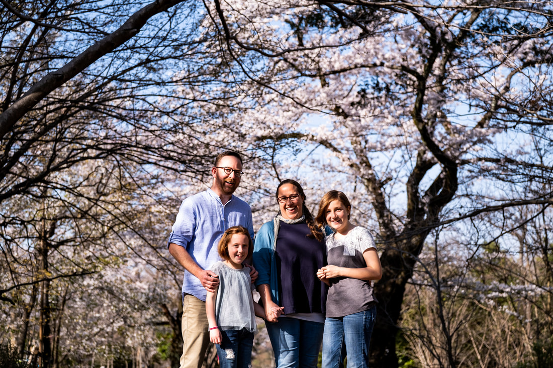 family under massive cherry tree