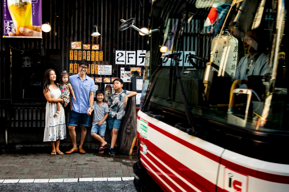 Bus passes family at Kichijoji Station