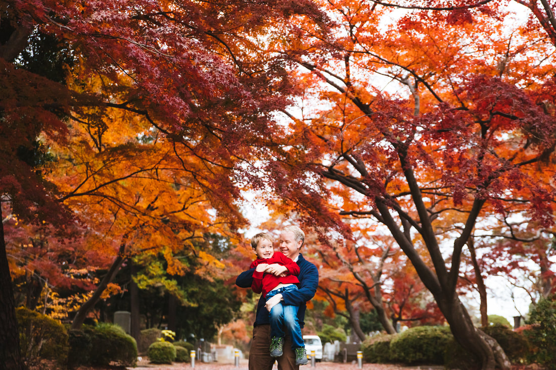 Father and son under maple trees