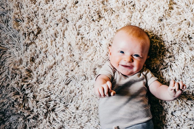 smiling baby on rug