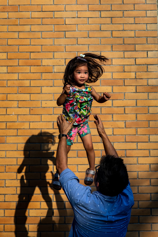 dad tosses daughter in air