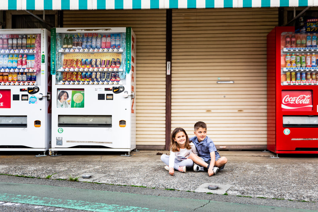 kids in front of Japanese vending machines
