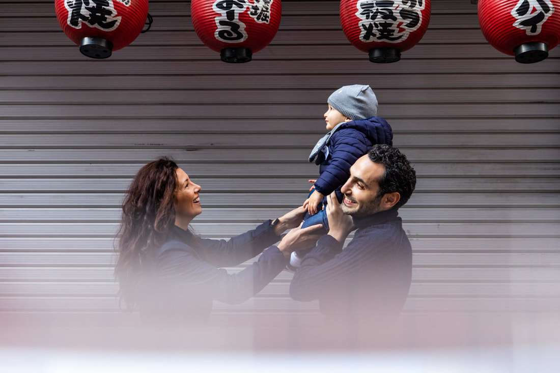 parents hoist child in Japan