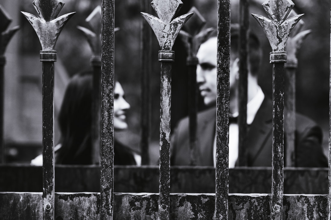couple behind iron gate