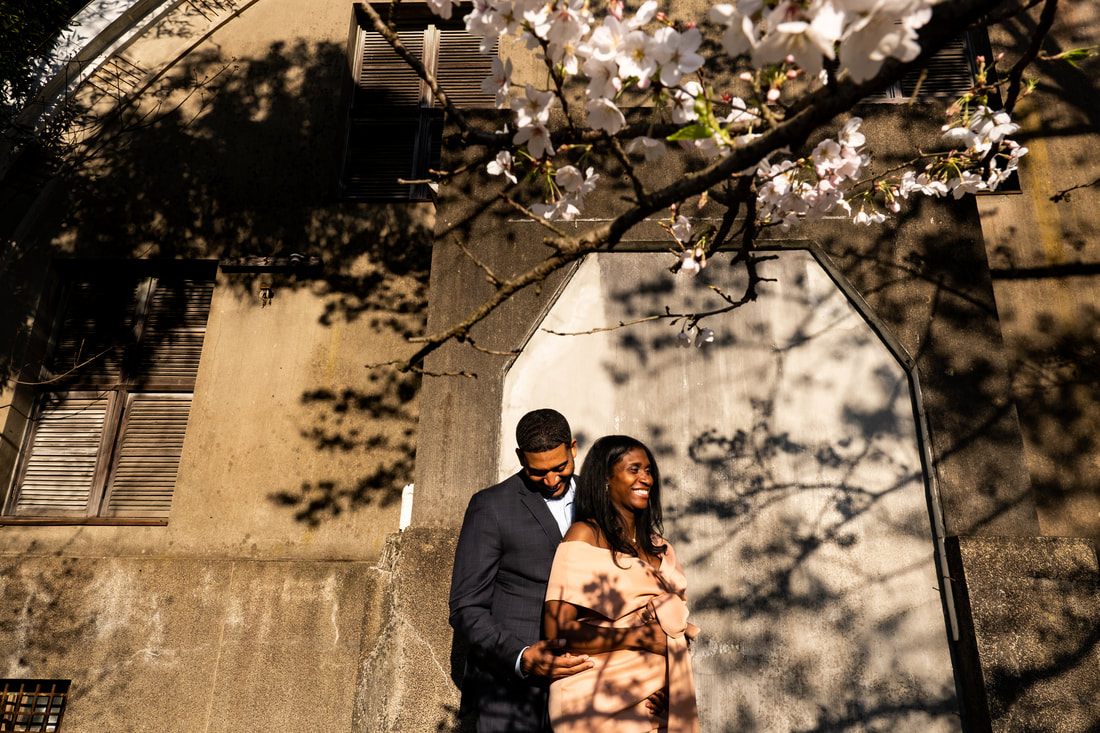 smiling couple under sakura blooms