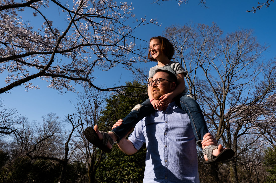 daughter on father's shoulders