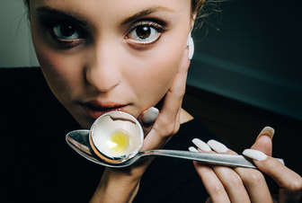 Girl Holding egg with spoon