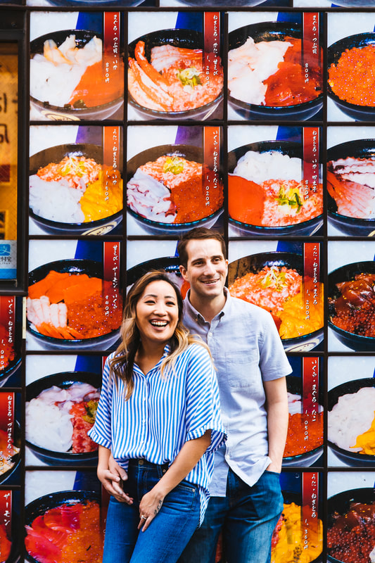 couple in front of sushi signage