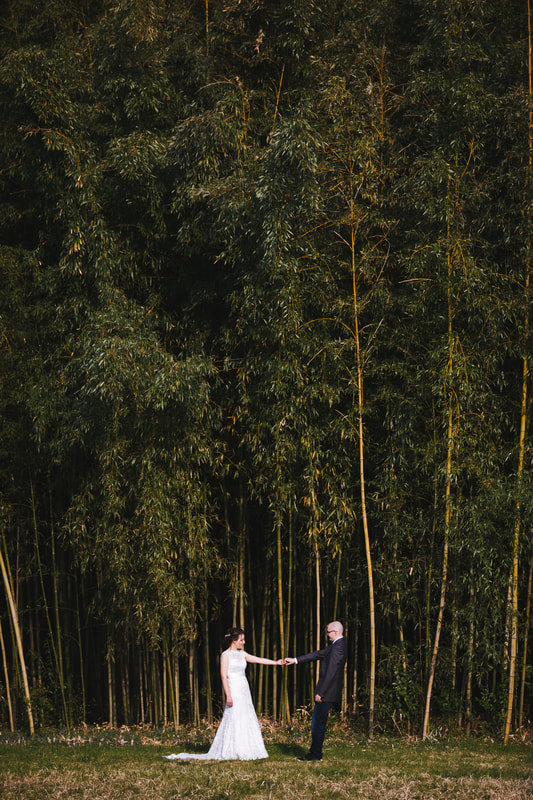 couples dancing next to bamboo