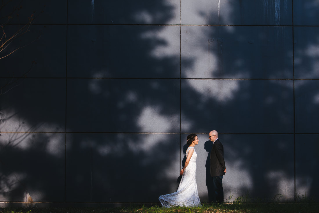 wedding portrait in front of massive wall