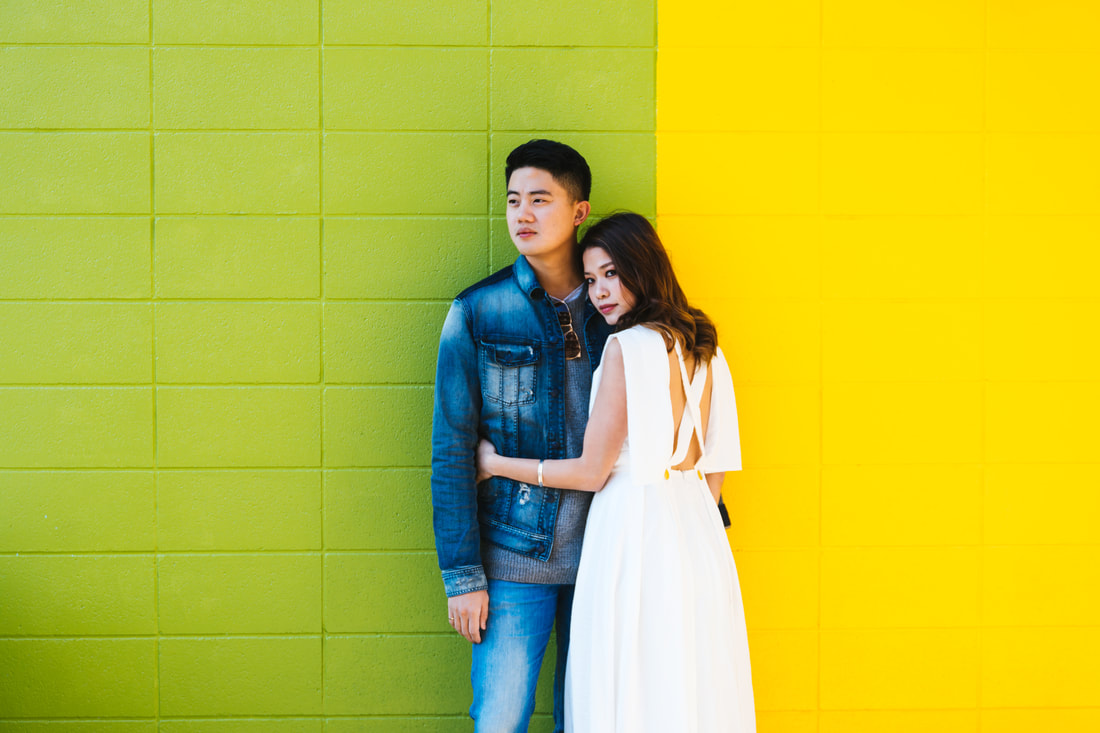 couple against colorful wall