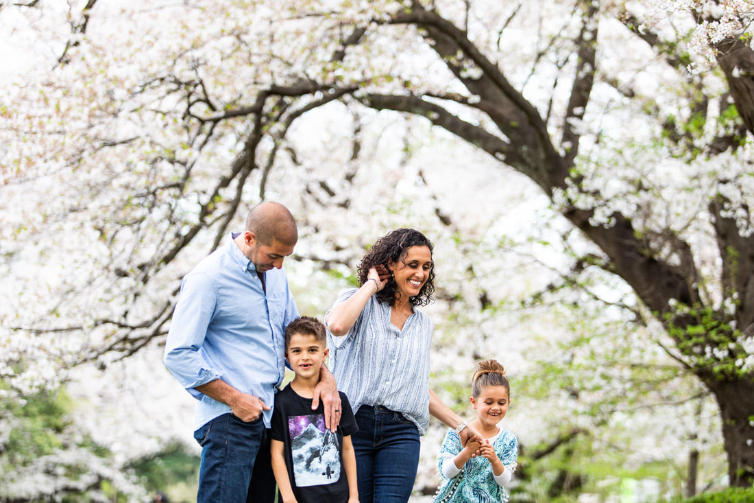 family surrounded by cherry blossoms