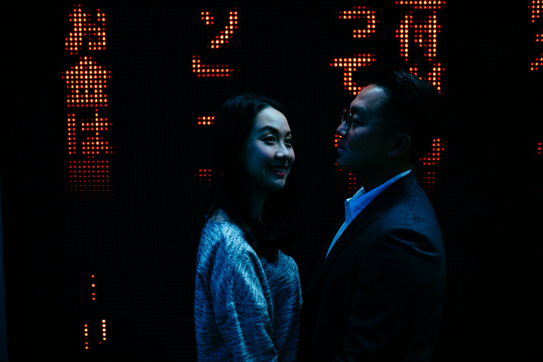 couple in front of neon